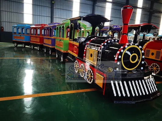 The front of the train features a black and red color scheme, accented with gold trim and white rivet details. The carriages use a rainbow color scheme, with each carriage displaying a different color.